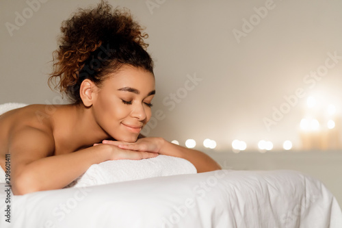 Health spa. Afro woman relaxing in spa with closed eyes