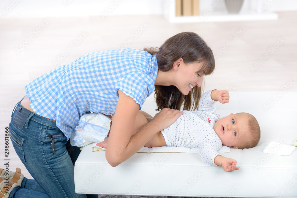a mother changing baby child a mother changing baby child