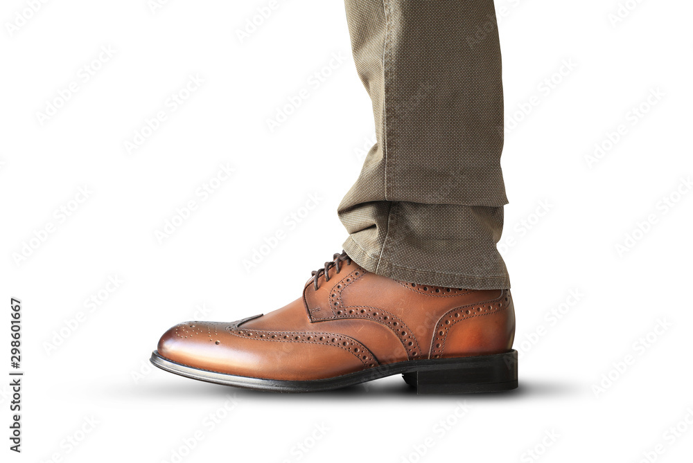 A man stands in brown classic leather men's shoes