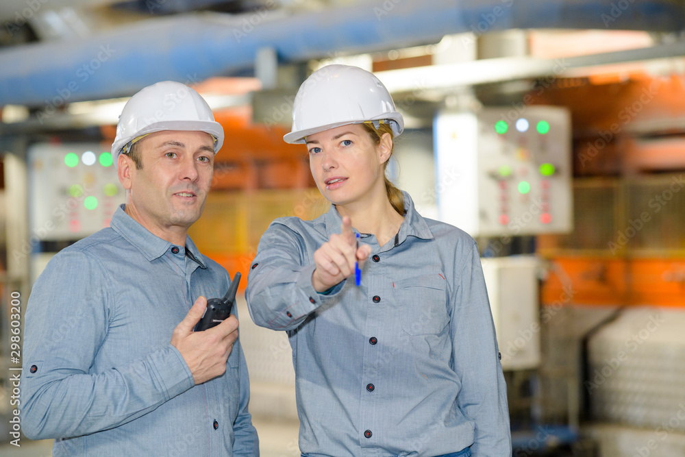 paper mill factory workers pointing at something paper mill factory workers pointing at something