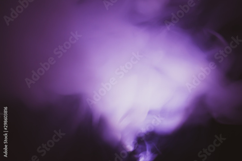 Violet smoke on black backdrop. abstract background with color fog