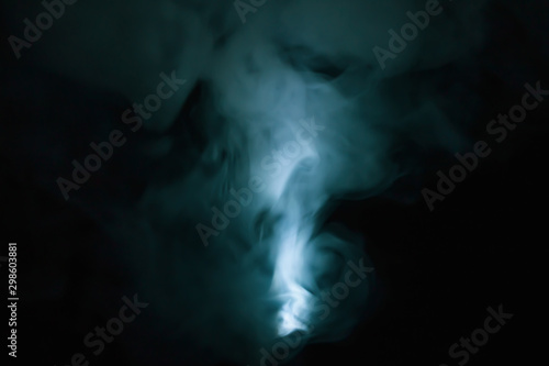 Turquoise smoke on black backdrop. abstract background with color fog © maxkolmeto