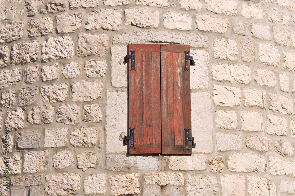 Old closed wooden window. Window in the old fortress. Old closed wooden window. Window in the old fortress.