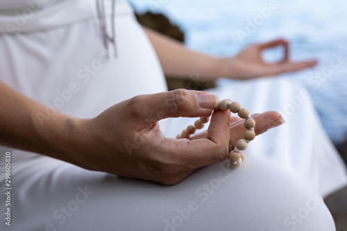 Pregnant woman on the beach relaxing and meditating 
