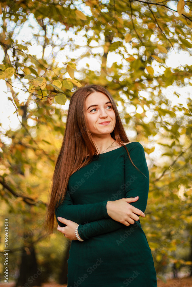 Autumn girl portraits. Emerald dress. Yellow leaves and trees. Park. Warm atmosphere. Autumn girl portraits. Emerald dress. Yellow leaves and trees. Park. Warm atmosphere.