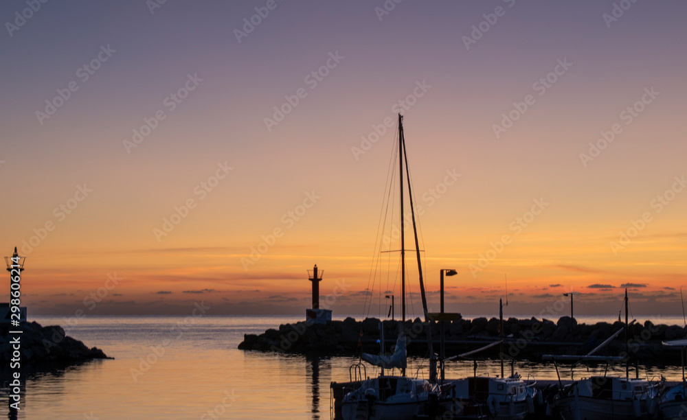 Cala Bona Majorca a beautiful sunrise over the Marina a rich orange glow just before the sun appears.