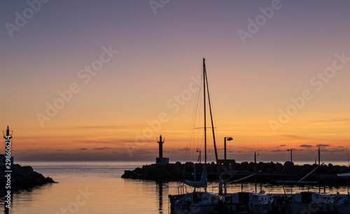 Cala Bona Majorca a beautiful sunrise over the Marina a rich orange glow just before the sun appears.