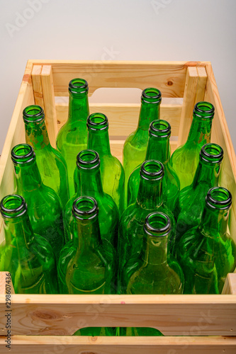 Empty wine bottles in a wooden box on the table. Home winemaking.