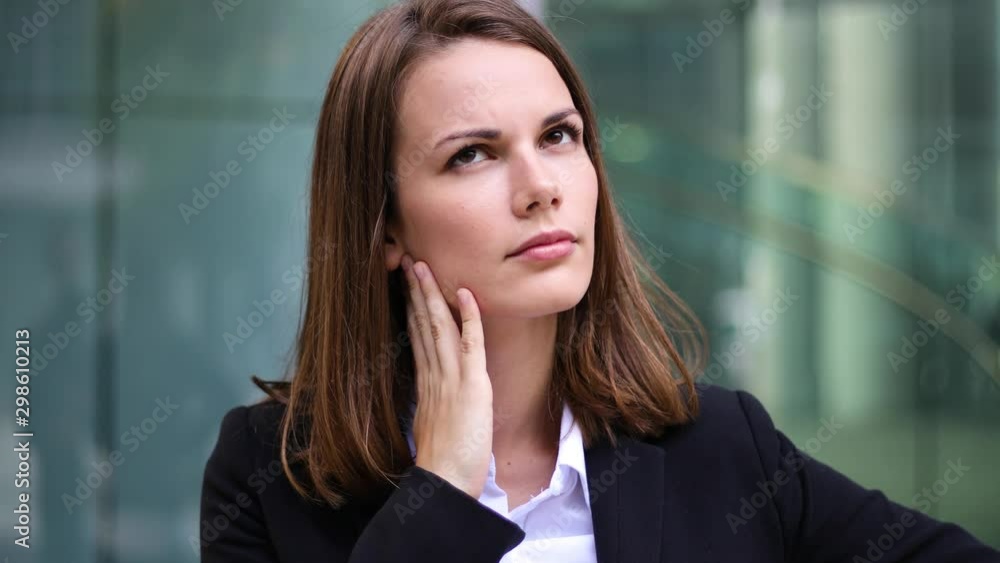 Smiling businesswoman poirtrait in a pensive expression Smiling businesswoman poirtrait in a pensive expression