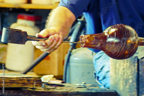 Glassworker in action in the Murano glassfactory photo