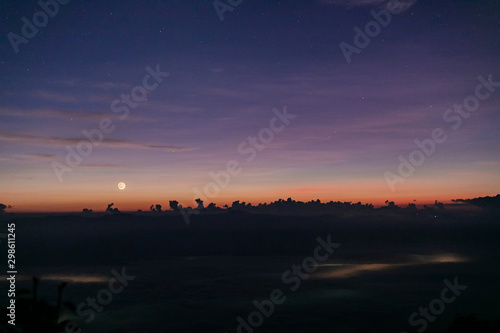 morning sunrise covered with fog and sky background with stars