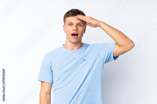 Young handsome man over isolated white background has just realized something and has intending the solution © luismolinero