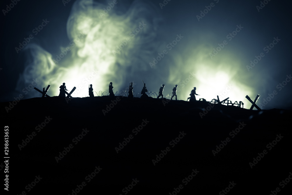 War Concept. Military silhouettes fighting scene on war fog sky background, World War German Tanks Silhouettes Below Cloudy Skyline At night. Attack scene. Armored vehicles and infantry.