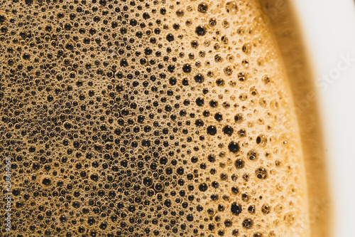 Coffee foam with bubbles macro texture. froth drink