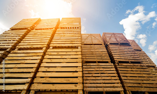 Obraz na plátně Wooden boxes stacked on each other. Outdoors. Blue sky background
