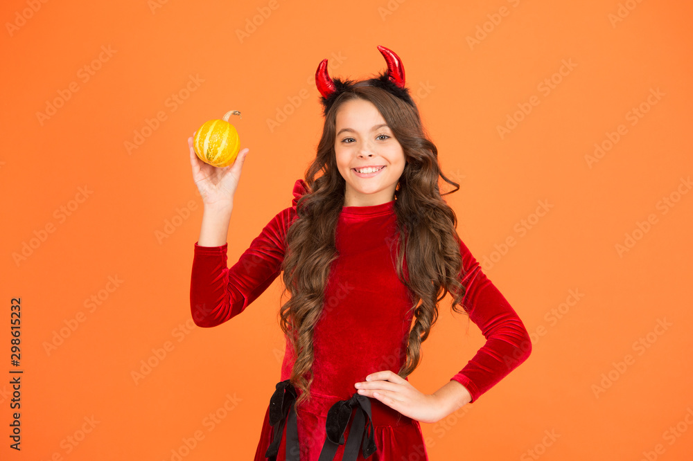 Pumpkin carving and ghost hunting. Halloween party child. Happy child hold pumpkin orange background. Little child wear red devil horns. Halloween look of small child girl. Holiday celebration Pumpkin carving and ghost hunting. Halloween party child. Happy child hold pumpkin orange background. Little child wear red devil horns. Halloween look of small child girl. Holiday celebration