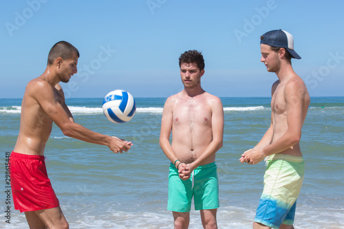 men playing beach volleyball game