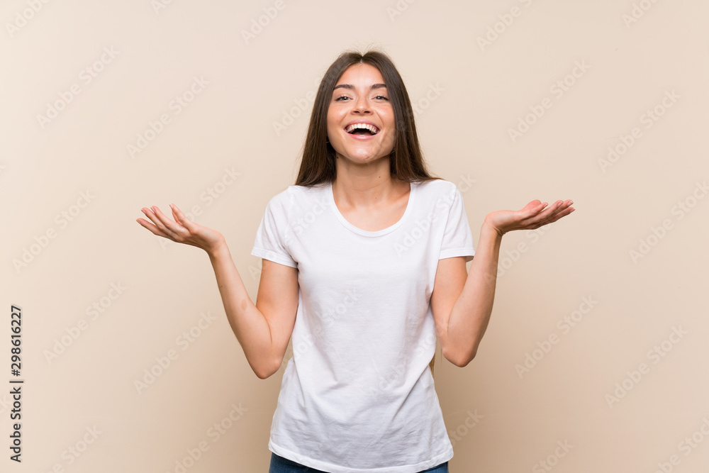 Pretty young girl over isolated background smiling a lot Pretty young girl over isolated background smiling a lot