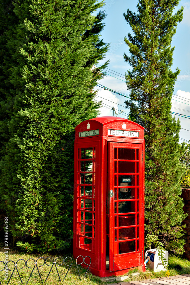 Old fashioned telephone box placed in the garden of Uroko house in Kobe, Hyogo, Japan Old fashioned telephone box placed in the garden of Uroko house in Kobe, Hyogo, Japan