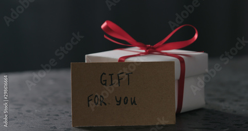 for you paper card next to white gift box on terrazzo countertop