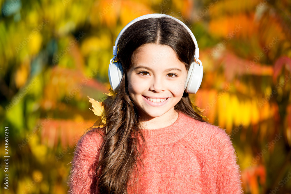 enjoy autumn day. good day for park walk. she love nature and music. school time season. fall mood. small girl listen audio book. little child in headset. online education. ebook for children enjoy autumn day. good day for park walk. she love nature and music. school time season. fall mood. small girl listen audio book. little child in headset. online education. ebook for children