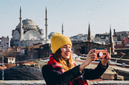 Canvas Print Young european woman takes a selfie portrait in Istanbul, Turkey