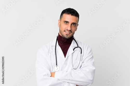 Young man over isolated white background with doctor gown