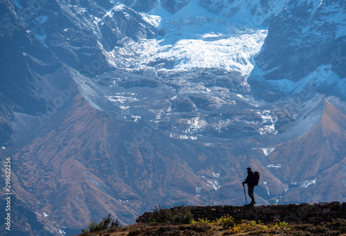 Active hiker hiking, enjoying the view  at Himalaya mountains and Mount Everest landscape. Travel sport lifestyle concept