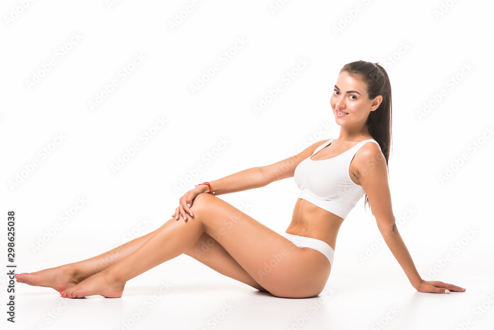 Fit and sporty beautiful woman with perfect shape. Girl in white underwear on the floor. Healthy lifestyle, sport, healthcare, nutrition and diet concept.