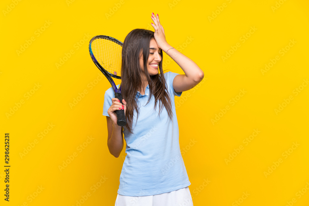 Young tennis player woman over isolated yellow wall has realized something and intending the solution Young tennis player woman over isolated yellow wall has realized something and intending the solution
