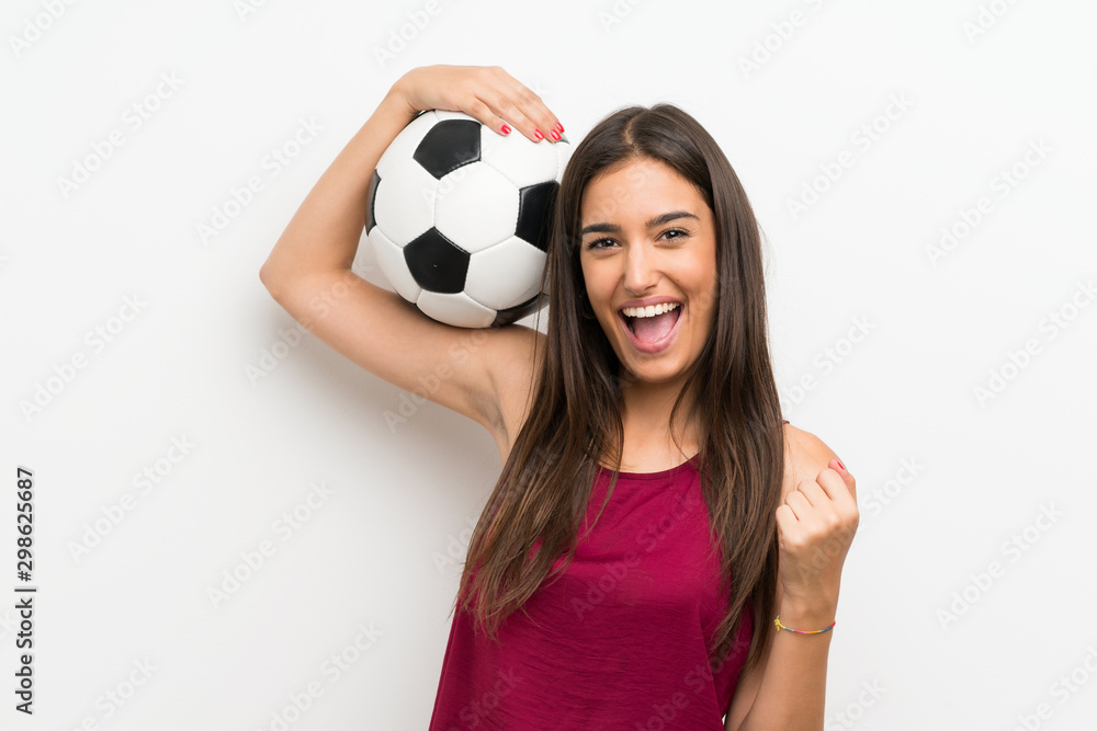 Young woman over isolated white background holding a soccer ball