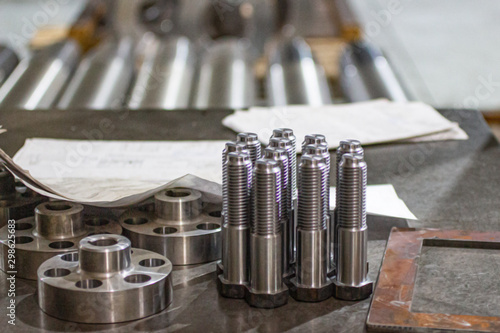 Steel bolts made of steel are made on a lathe. photo