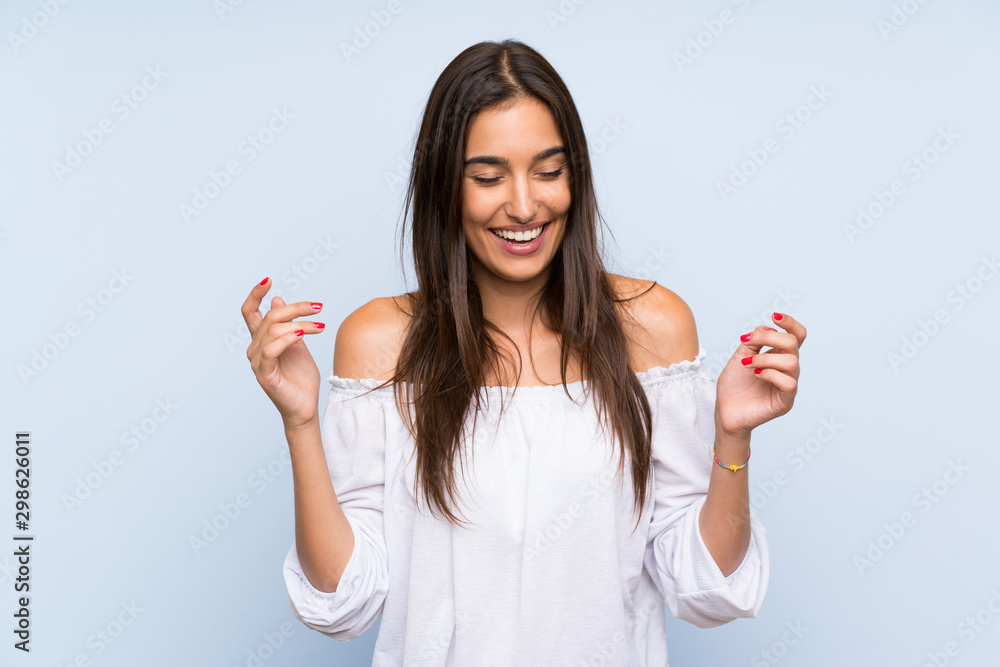 Young woman over isolated blue background laughing Young woman over isolated blue background laughing