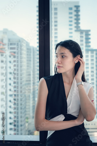 Portrait of Businesswoman is Standing Against With Office Windows Overlooking City Skyscrapers Building. Confidence of Smart Modern Woman in Company Workplace, Job Career/Financial Occupation Concept Free Download Portrait of Businesswoman is Standing Against With Office Windows Overlooking City Skyscrapers Building. Confidence of Smart Modern Woman in Company Workplace, Job Career/Financial Occupation Concept - GFXLoad