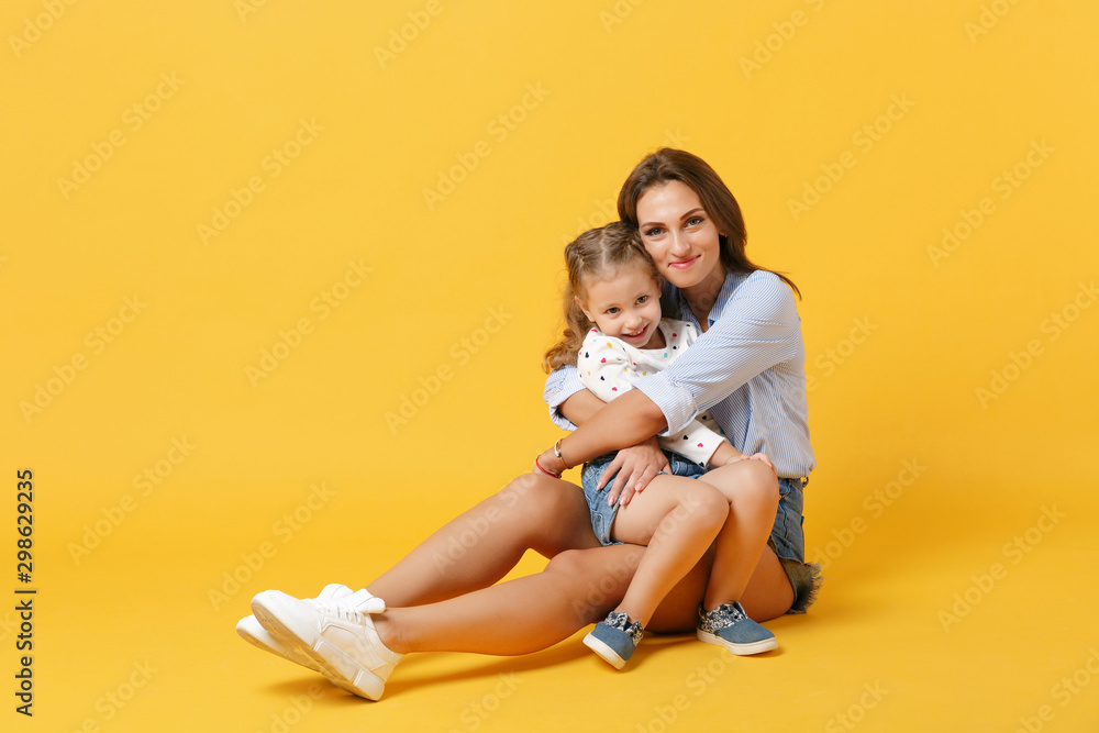 Woman in light clothes have fun with cute child baby girl 4-5 years old. Mommy little kid daughter isolated on yellow background studio portrait. Mother's Day love family parenthood childhood concept. Woman in light clothes have fun with cute child baby girl 4-5 years old. Mommy little kid daughter isolated on yellow background studio portrait. Mother's Day love family parenthood childhood concept.