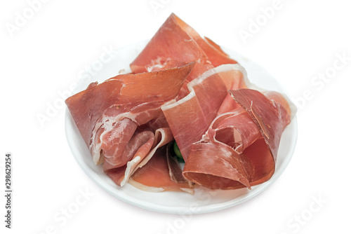 Jamon dry ham slices on small dish isolated