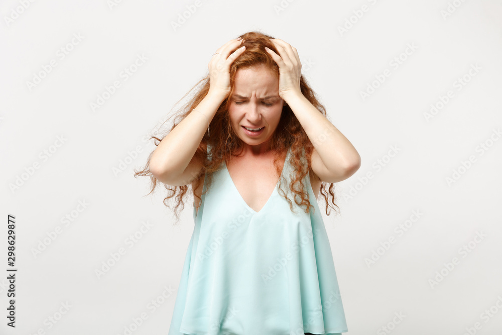 Young frustrated redhead woman in casual light clothes posing isolated on white background. People sincere emotions lifestyle concept. Mock up copy space. Putting hands on head, keeping eyes closed. Young frustrated redhead woman in casual light clothes posing isolated on white background. People sincere emotions lifestyle concept. Mock up copy space. Putting hands on head, keeping eyes closed.