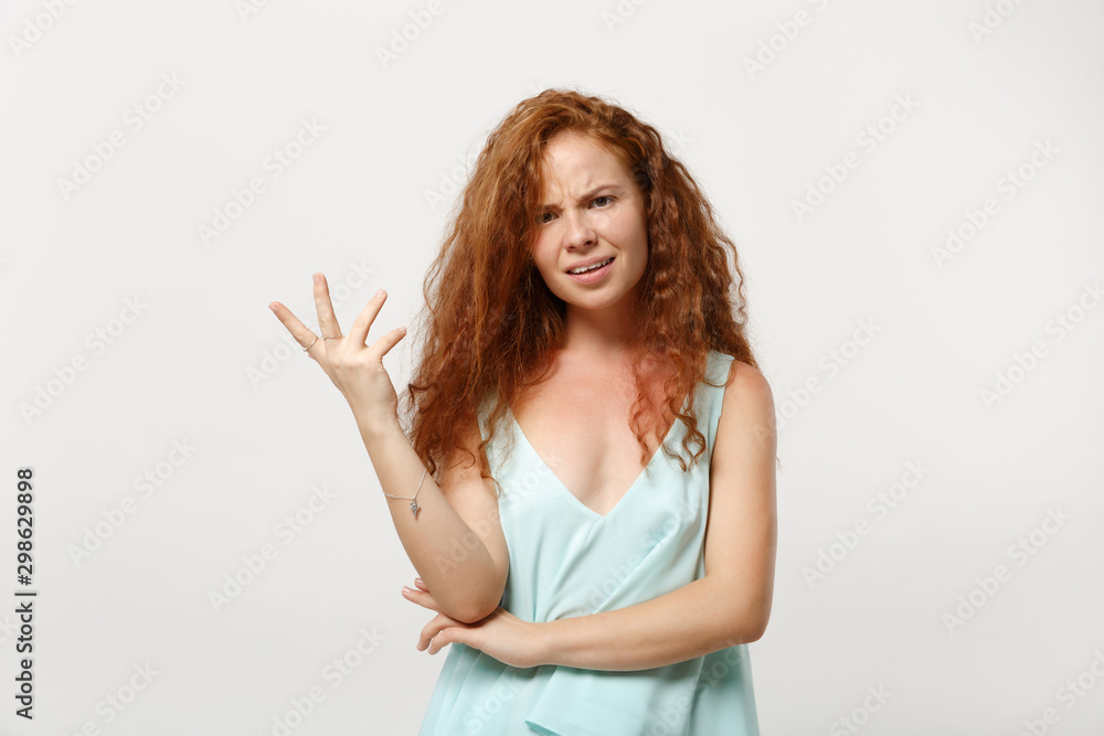 Young perplexed irritated redhead woman girl in casual light clothes posing isolated on white wall background, studio portrait. People lifestyle concept. Mock up copy space. Swearing, spreading hands. Young perplexed irritated redhead woman girl in casual light clothes posing isolated on white wall background, studio portrait. People lifestyle concept. Mock up copy space. Swearing, spreading hands.