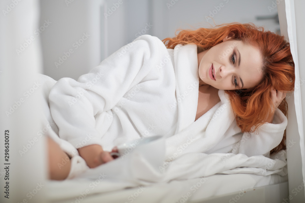 Beautiful girl at her bedroom drinking tea in the morning. Beautiful girl at her bedroom drinking tea in the morning.