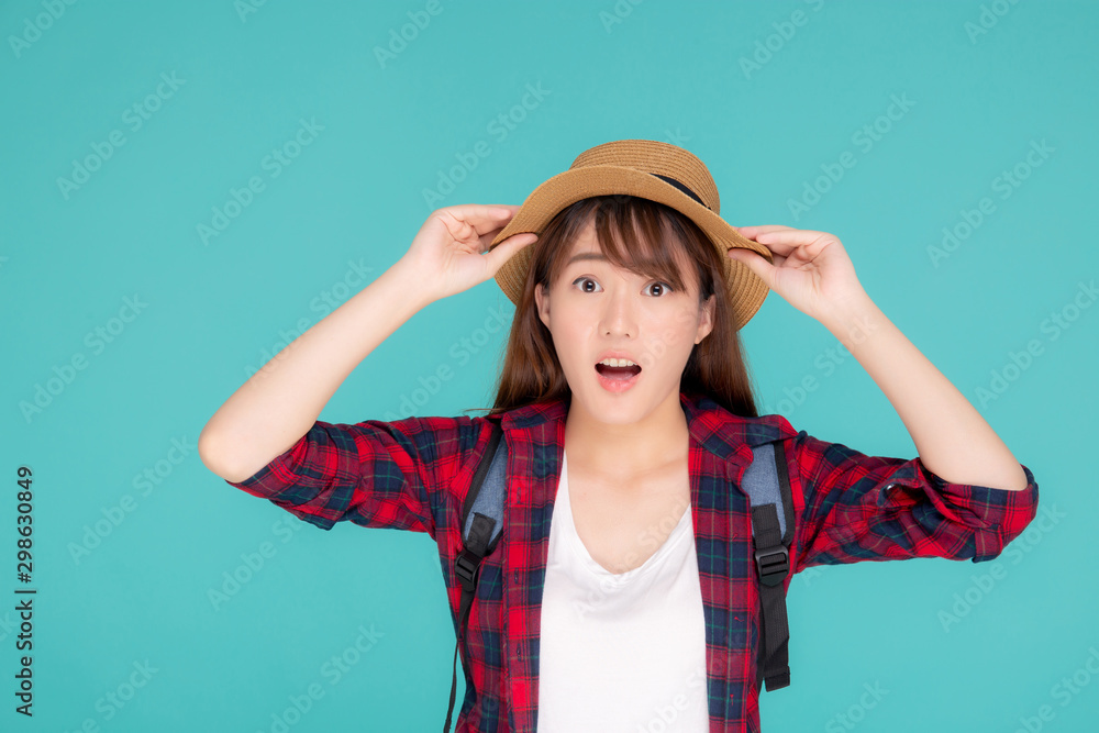 Fototapeta premium Beautiful portrait young asian woman smiling and surprise wearing travel summer fashion tourist in vacation isolated on blue background, girl shocked expression and emotion, holiday concept.