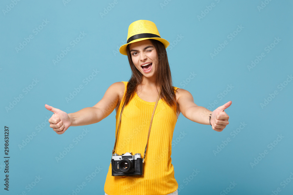 Traveler tourist woman in yellow summer casual clothes, hat with photo camera isolated on blue background. Female passenger traveling abroad to travel on weekends getaway. Air flight journey concept. Traveler tourist woman in yellow summer casual clothes, hat with photo camera isolated on blue background. Female passenger traveling abroad to travel on weekends getaway. Air flight journey concept.