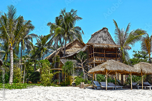 Beautiful Bungalow on a tropical island. Palm trees  sea and white sand. Houses in the jungle.