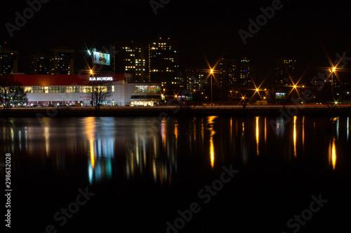 night city with lanterns and reflection in water