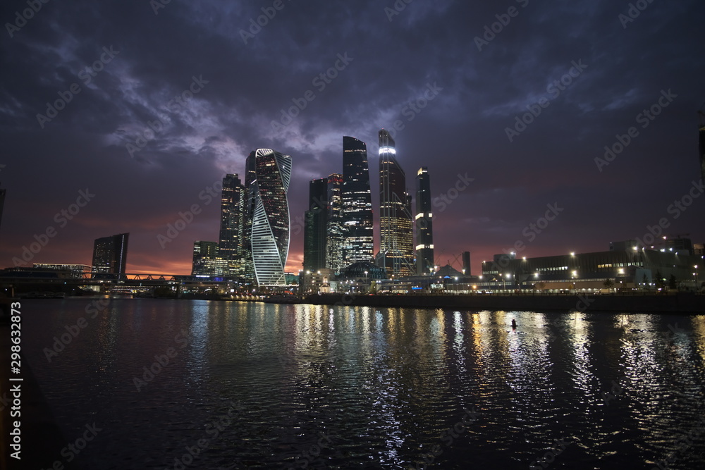 Moscow city at night on a background of purple sky with pink clouds