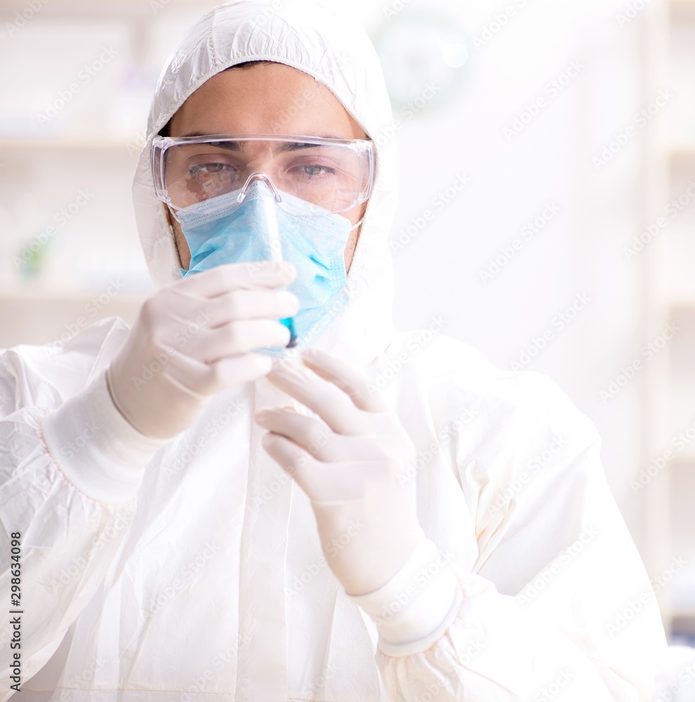 Young chemist student working in lab on chemicals Young chemist student working in lab on chemicals