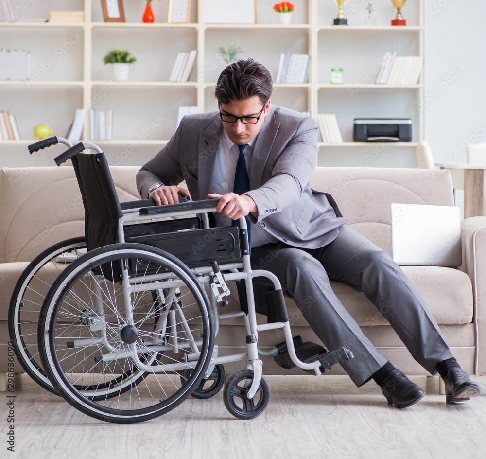 Dsabled businessman on wheelchair working home Dsabled businessman on wheelchair working home