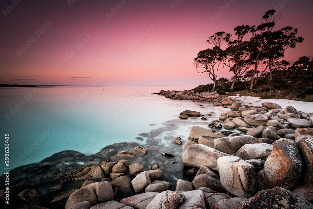 Dreamlike sunset on Binalong Bay in Tasmania, also called the Bay of Fires, a picturesque landscape and coastline of Australia's largest island, on a mild spring day on the east coast of Tassie