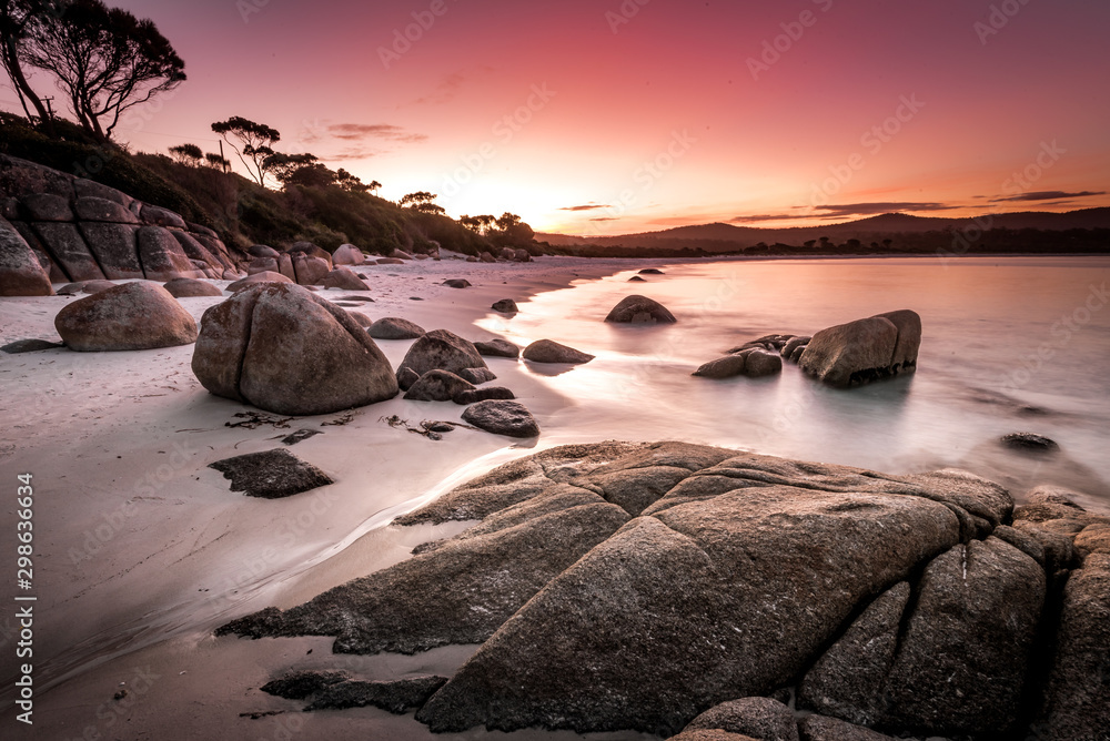 Dreamlike sunset on Binalong Bay in Tasmania, also called the Bay of Fires, a picturesque landscape and coastline of Australia's largest island, on a mild spring day on the east coast of Tassie