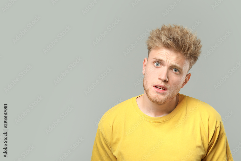 Portrait of surprised man on grey background Portrait of surprised man on grey background