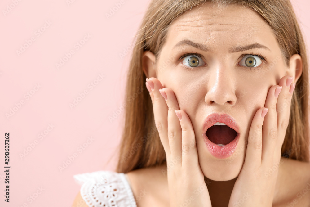 Surprised young woman on color background Surprised young woman on color background